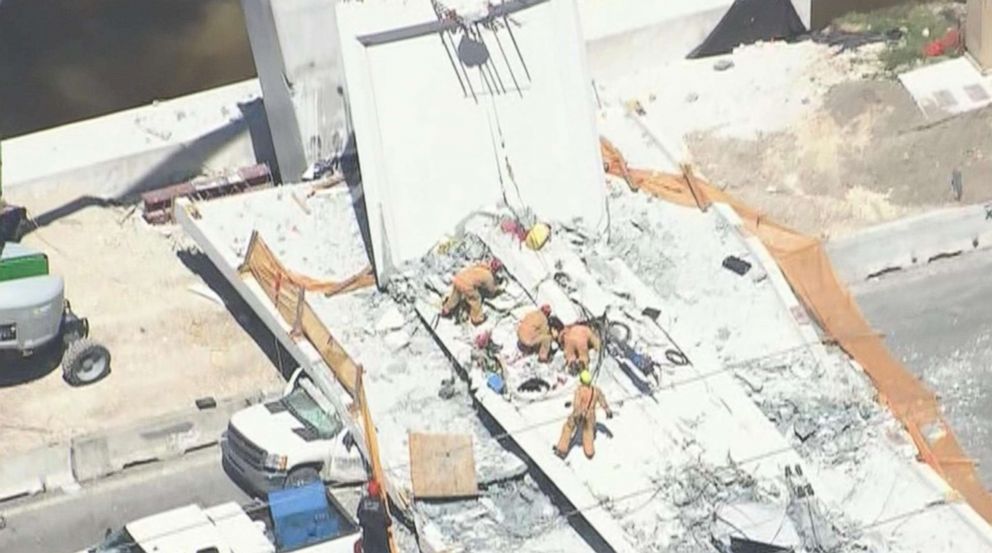 PHOTO: First responders were seen tending to injured victims on the scene of a pedestrian bridge that collapsed on the Florida International University campus in Miami, March 15, 2018.