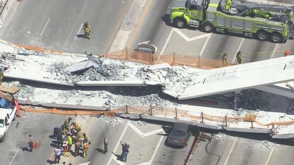 PHOTO: First responders were seen tending to injured victims on the scene of a pedestrian bridge that collapsed on the Florida International University campus in Miami, March 15, 2018.