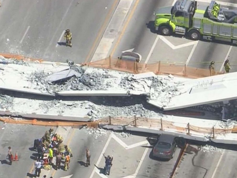 PHOTO: First responders were seen tending to injured victims on the scene of a pedestrian bridge that collapsed on the Florida International University campus in Miami, March 15, 2018.