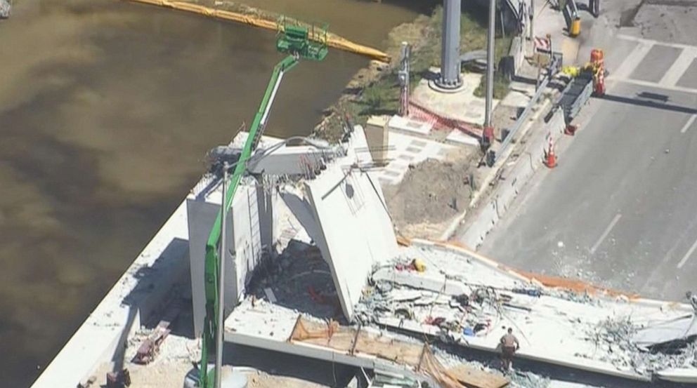 PHOTO: First responders were seen tending to injured victims on the scene of a pedestrian bridge that collapsed on the Florida International University campus in Miami, March 15, 2018.