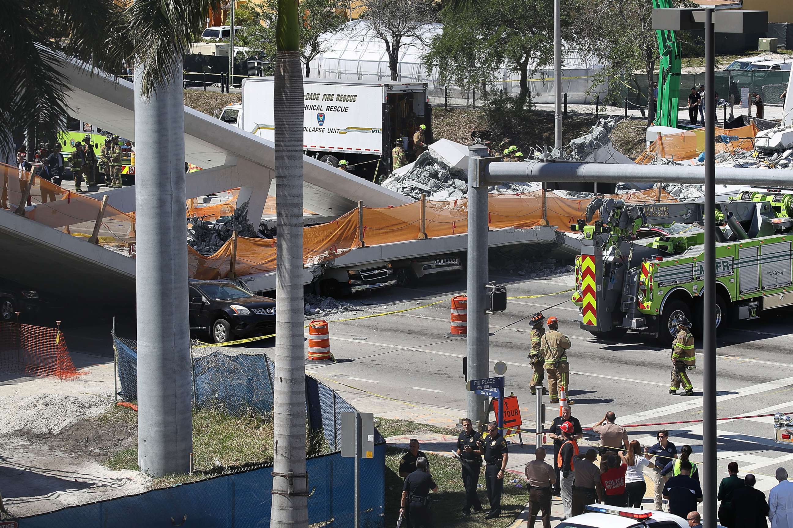 PHOTO: Vehicles are seen trapped under the collapsed pedestrian bridge that was newly built over southwest 8th street allowing people to bypass the busy street to reach Florida International University, March 15, 2018 in Miami. 