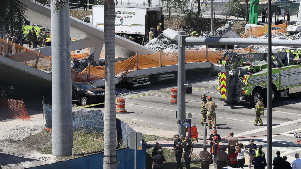 PHOTO: Vehicles are seen trapped under the collapsed pedestrian bridge that was newly built over southwest 8th street allowing people to bypass the busy street to reach Florida International University, March 15, 2018 in Miami. 