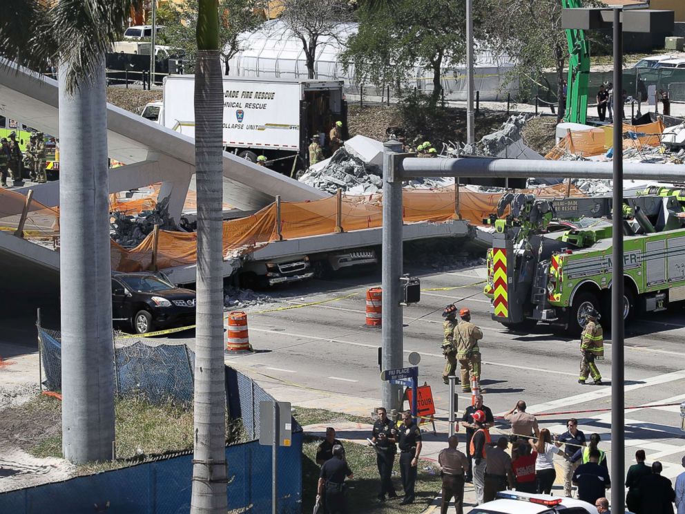 PHOTO: Vehicles are seen trapped under the collapsed pedestrian bridge that was newly built over southwest 8th street allowing people to bypass the busy street to reach Florida International University, March 15, 2018 in Miami.