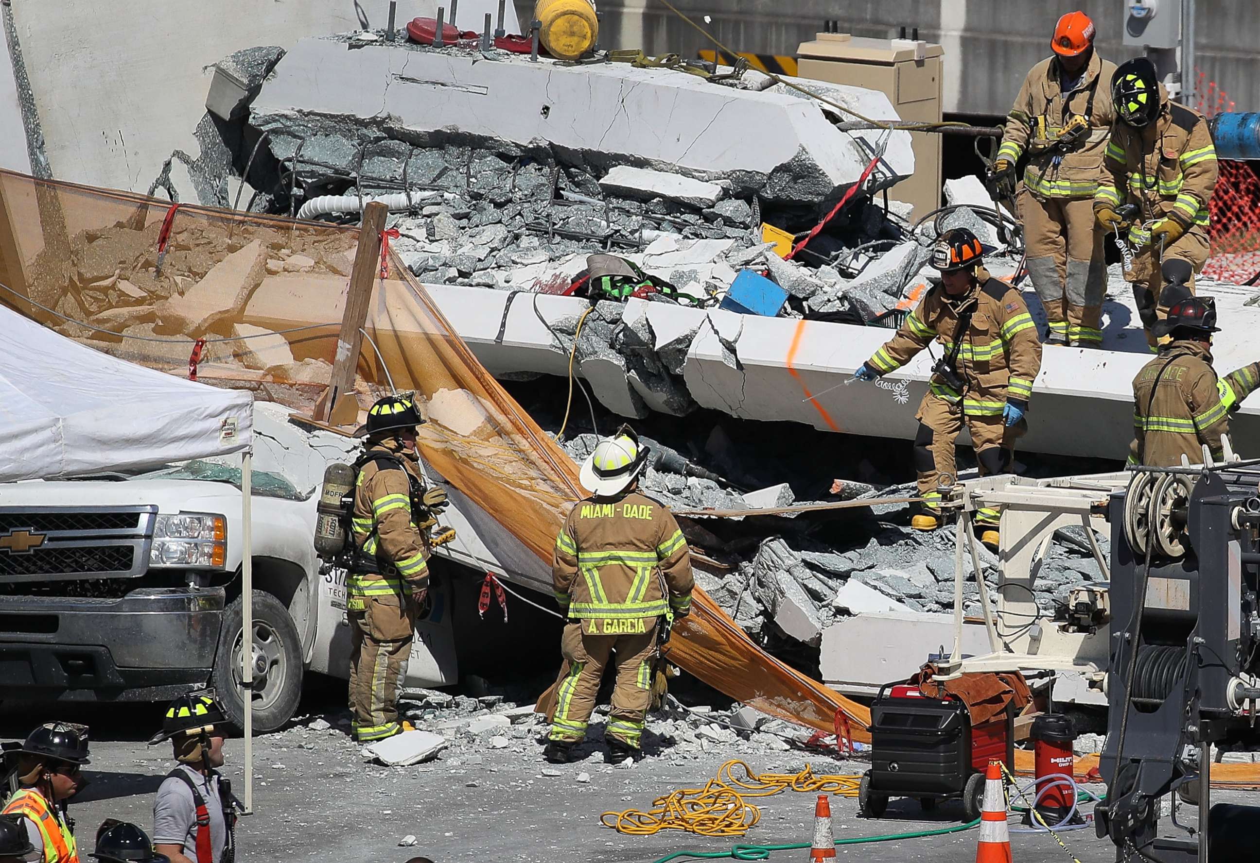 PHOTO: Miami-Dade Fire Rescue Department personnel and other rescue units work at the scene where a pedestrian bridge collapsed a few days after it was built on the Florida International University, March 15, 2018, in Miami. 