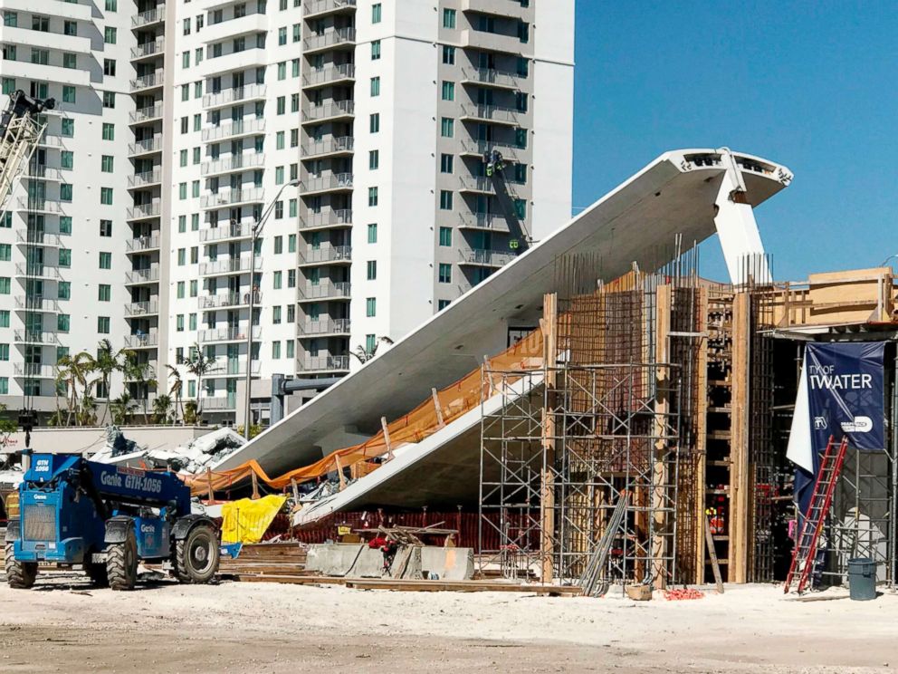 PHOTO: A crane is seen near a newly installed pedestrian bridge, that collapsed, over a six-lane highway in Miami, March 15, 2018.