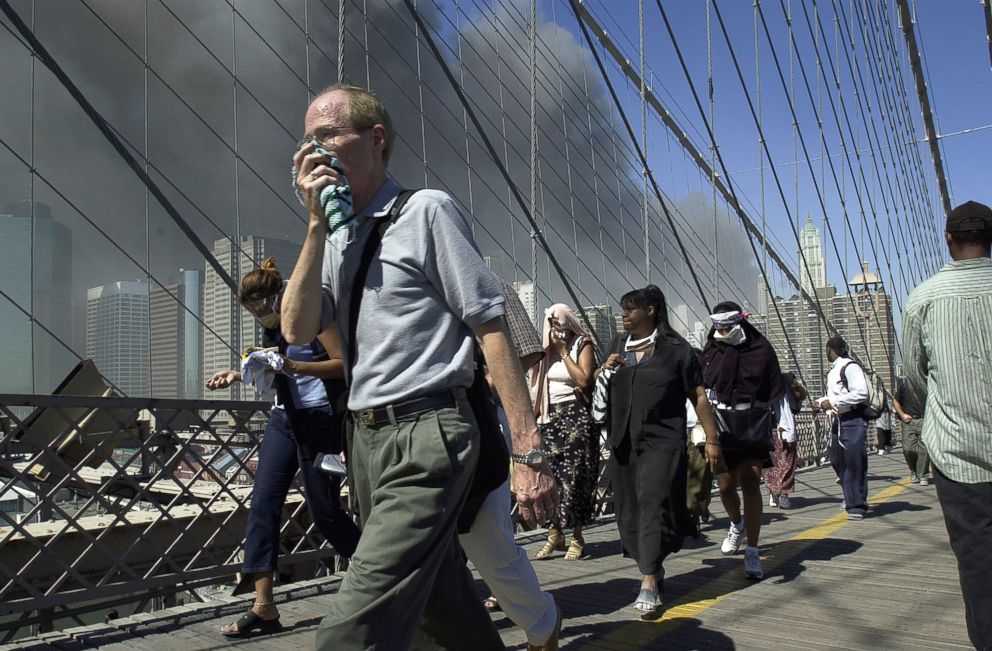 PHOTO: People walk over New York's Brooklyn Bridge from Manhattan to Brooklyn following the collapse of both World Trade Center towers on Sept. 11, 2001.