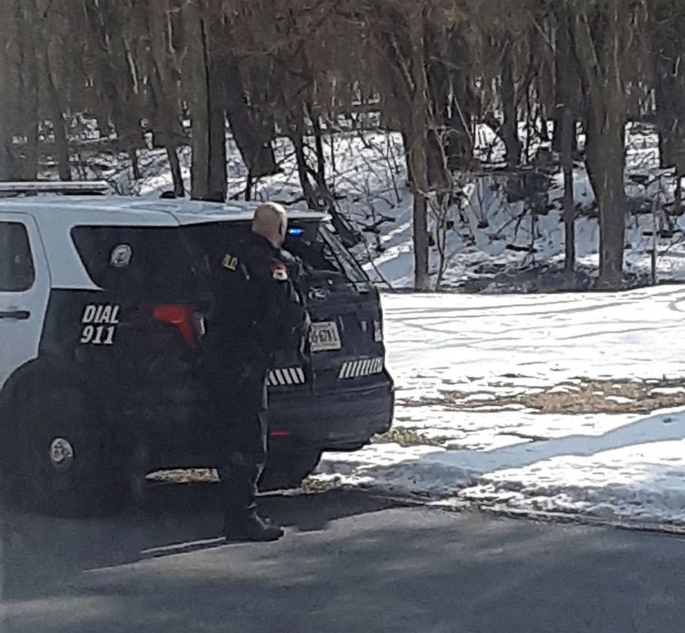 PHOTO: A law enforcement officer takes cover in the area of Bridgewater College in Bridgewater, Va., Feb. 1, 2022, while responding to an active shooter alert.