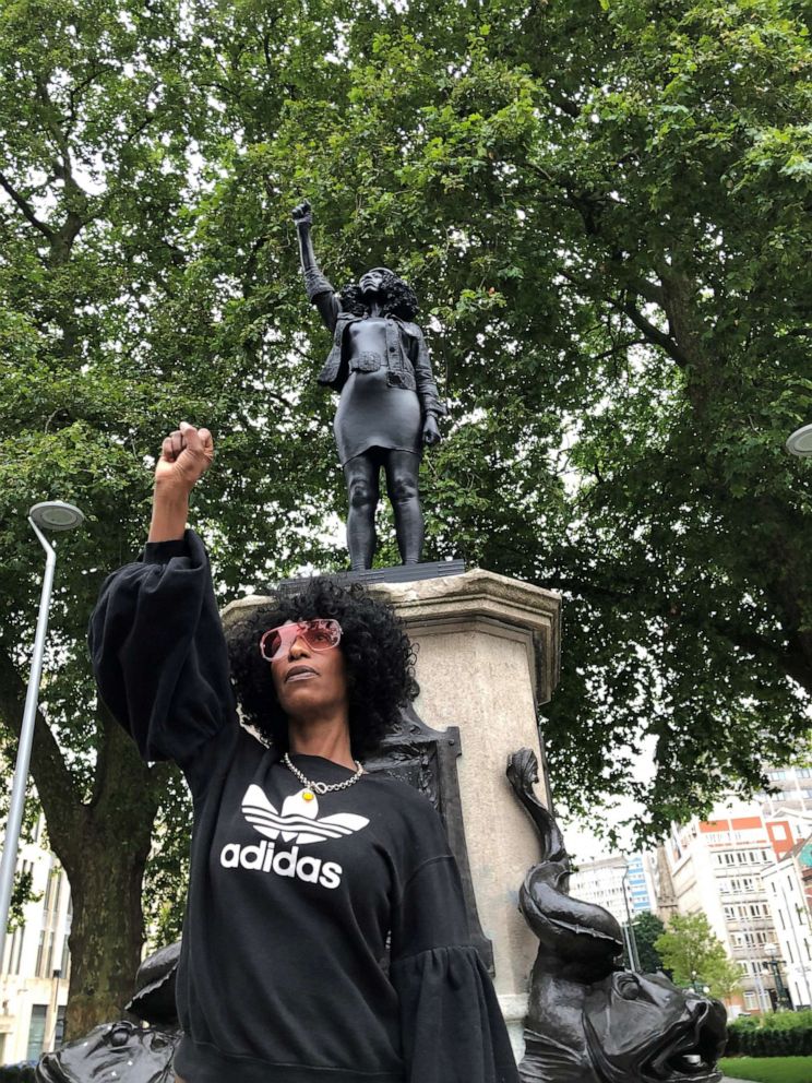 PHOTO: Jen Reid poses in front of her sculpture titled 'A Surge of Power (Jen Reid) 2020', created by Marc Quinn, as previously occupied by the statue of a slave trader Edward Colston, in Bristol, Britain June 7, 2020.