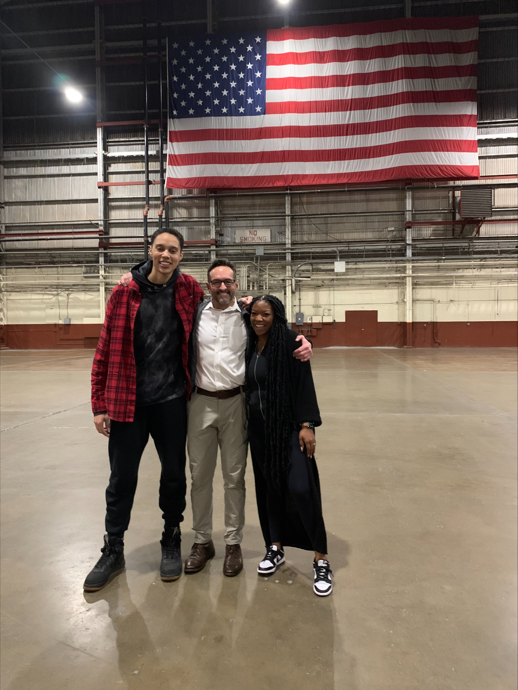 PHOTO: Basketball player Brittney Griner stands with U.S. Special Presidential Envoy for Hostage Affairs Roger Carstens and her wife Cherelle after arriving in the U.S. following her release by Russia. 