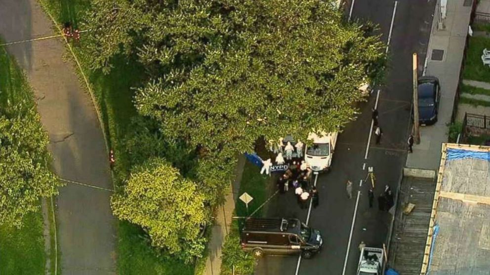 Police investigate where two bags of human remains were found on the side of the street just south of Crotona Park in the Bronx, New York, on Friday, Aug. 24, 2018.