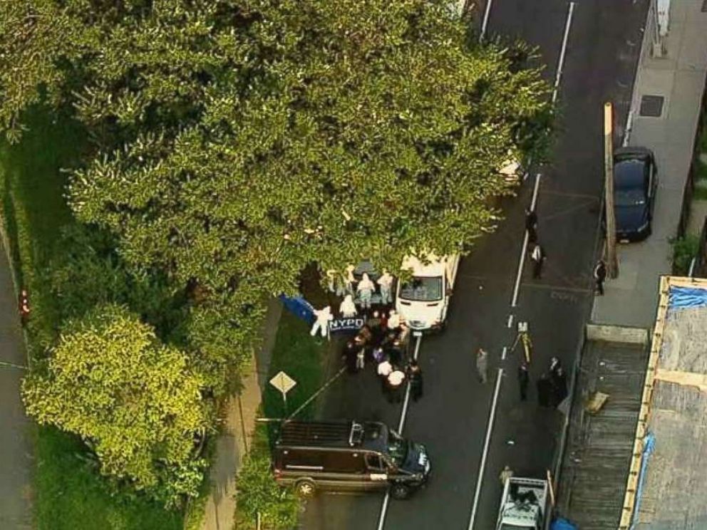 Police investigate where two bags of human remains were found on the side of the street just south of Crotona Park in the Bronx, New York, on Friday, Aug. 24, 2018.
