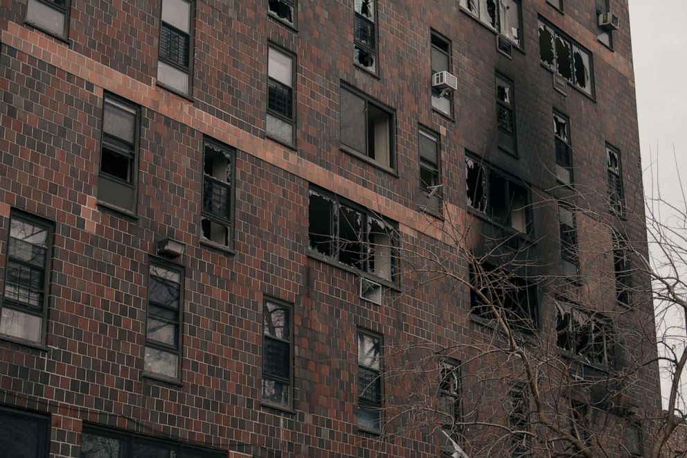 PHOTO: Broken windows and charred bricks mark the exterior of a 19-story residential building after a fire erupted in the morning, Jan. 9, 2022, in the Bronx, New York City.
