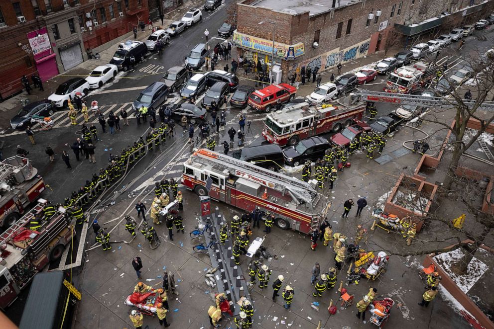 PHOTO: Firefighters work outside an apartment building after a fire in the Bronx, Jan. 9, 2022, in New York.