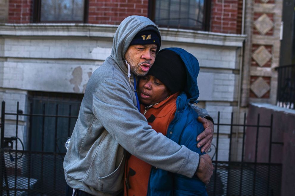 PHOTO: Emelia Ascheampong, right, a resident of the building where at least 12 people died in a fire, is embraced by a friend, Dec. 29, 2017, in the Bronx borough of New York. Ascheampong, her husband and four children, survived by using a fire escape.