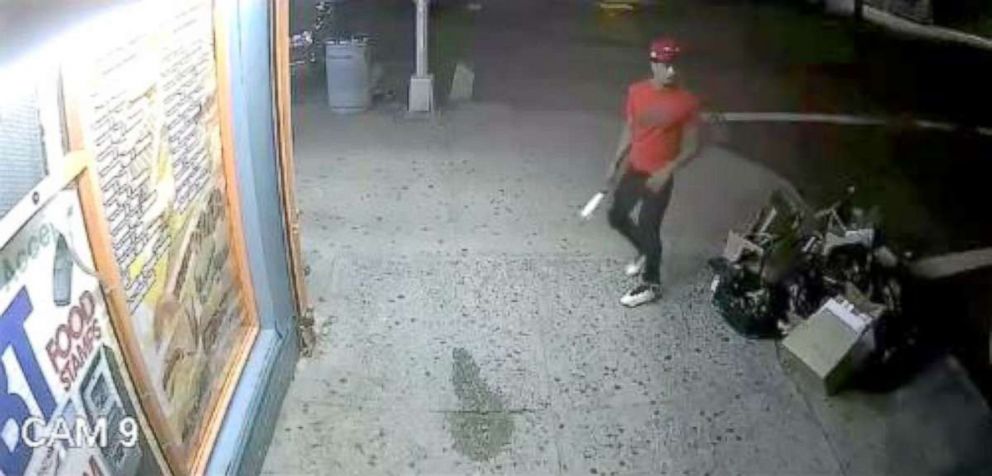 PHOTO: Police release a video surveillance showing a man in the red T-shirt as part of a group of men who allegedly hacked Lesandro Guzman-Feliz, 15, with a knife to death in the Bronx on June, 2018. 