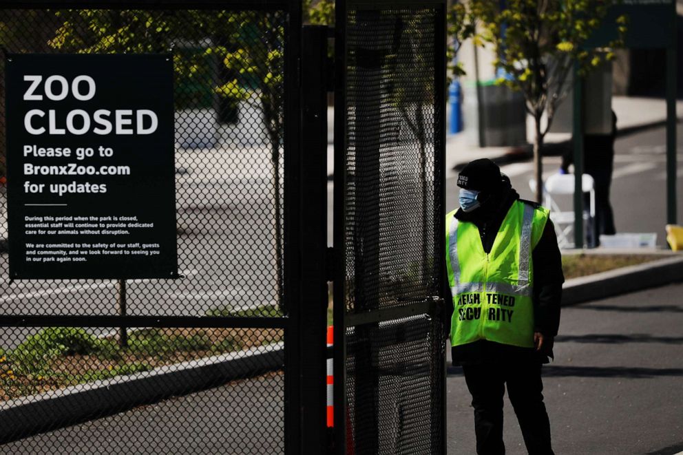 PHOTO: A guard stands at the entrance to the Bronx Zoo on April 06, 2020, in New York.