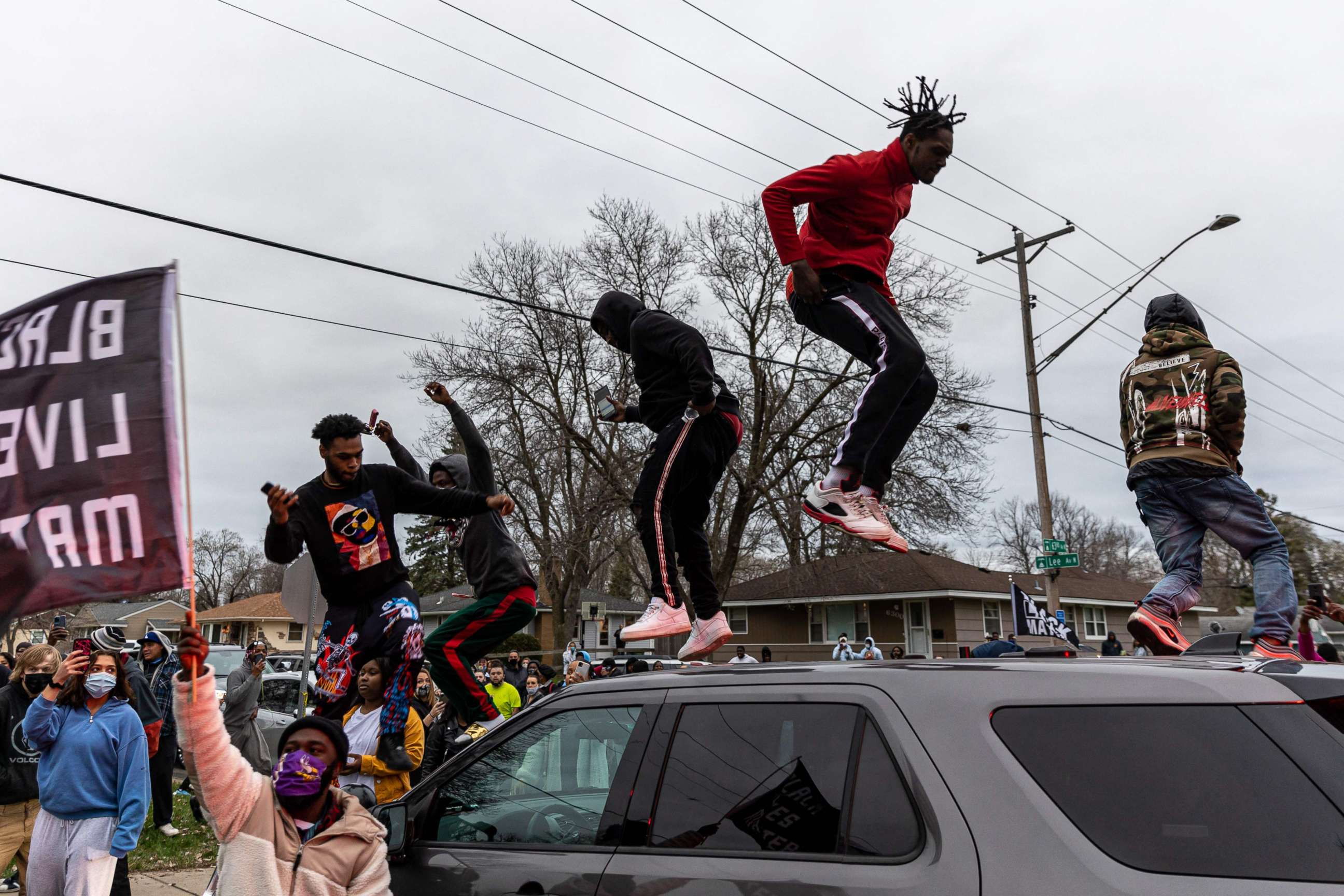 PHOTO: Protesters stand on top of a car as they clash with police after an officer shot and killed a driver during a traffic stop in Brooklyn Center, Minnesota, on April 11, 2021.