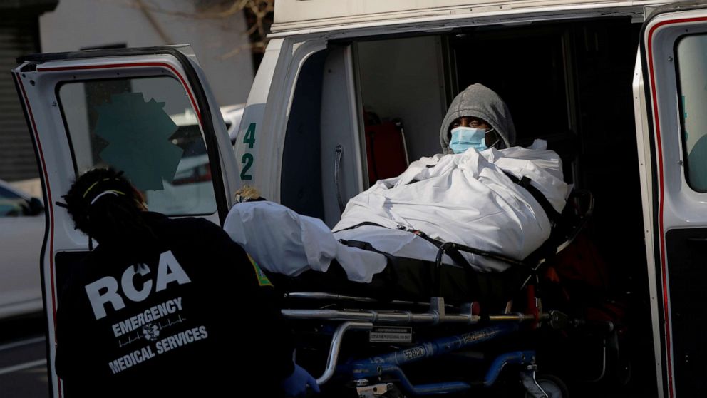 PHOTO: E.M.T.'s load a patient into an ambulance as health workers continued to test people for coronavirus disease (COVID-19) outside the Brooklyn Hospital Center in Brooklyn, New York, March 27, 2020.