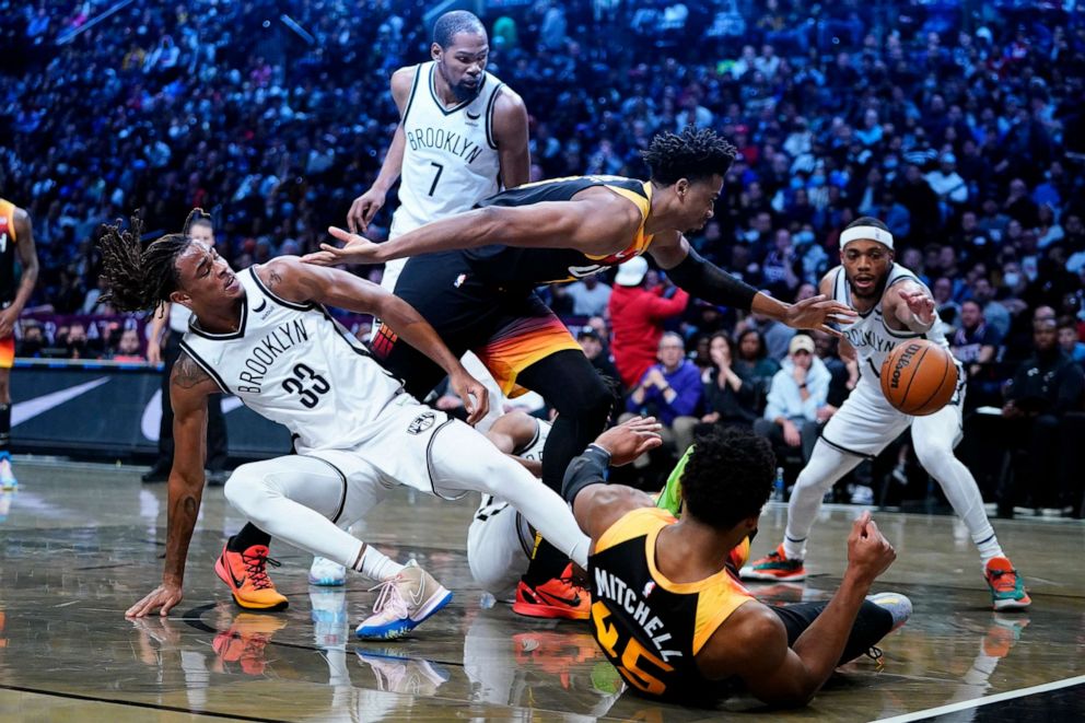 PHOTO: Utah Jazz's Hassan Whiteside, center, and Brooklyn Nets' Bruce Brown fight for control of the ball as Nets' Nic Claxton and Kevin Durant watch during the second half of an NBA basketball game on March 21, 2022, in New York.