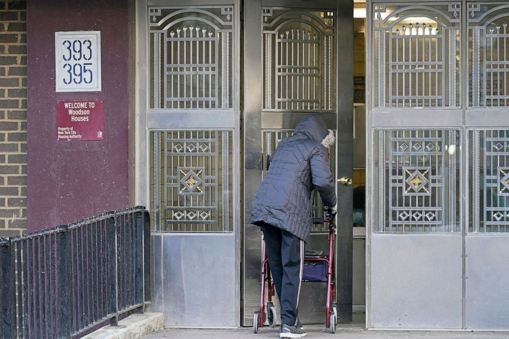 PHOTO: A senior citizen uses a walker while entering the doors at Woodson Houses, in the Brooklyn borough of New York, Jan. 21, 2021. 