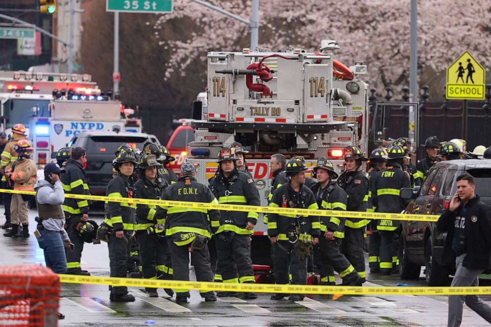 PHOTO: New York City Police and Fire Department officials on the scene of a shooting at a New York City Subway station in the Brooklyn borough of New York City, April 12, 2022.
