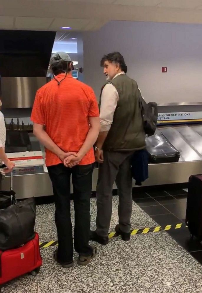 PHOTO: Isabel Godoy's uncle turns around to see his brother at Anchorage airport baggage claim for the first time since they went their separate ways more than two decades ago.