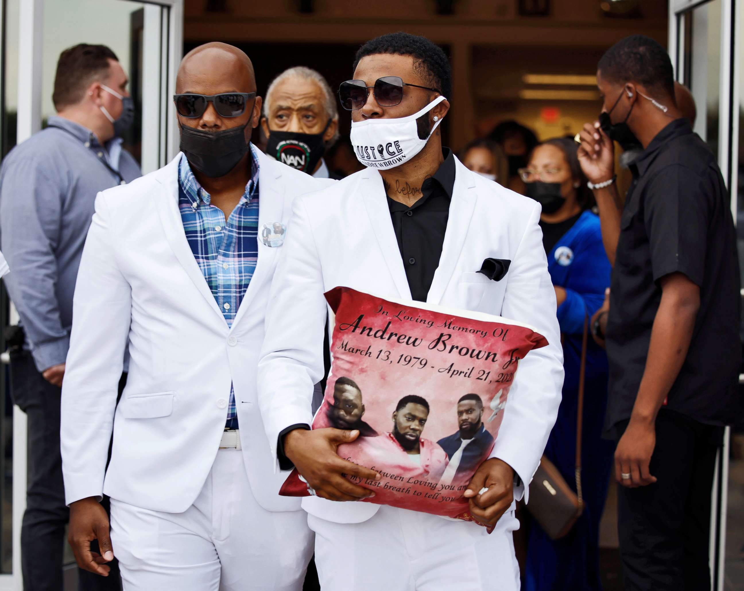 PHOTO: Jha'rod Ferebee, son of Andrew Brown Jr., carries one of the commemorative pillows that was given to each close relative as he leaves the church following funeral services in Elizabeth City, N.C., May 3, 2021.