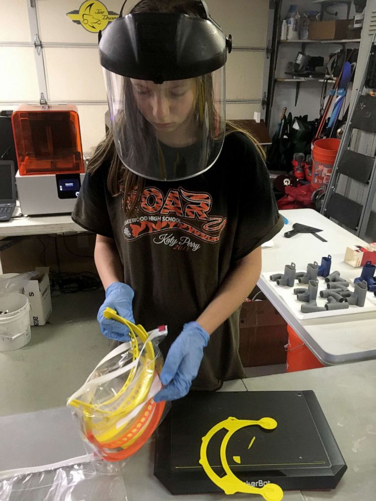 PHOTO: Colorado seventh-grader Amelia Brown, 12, works with her father to produce face shield parts which are donated to local hospitals fighting the novel coronavirus pandemic.