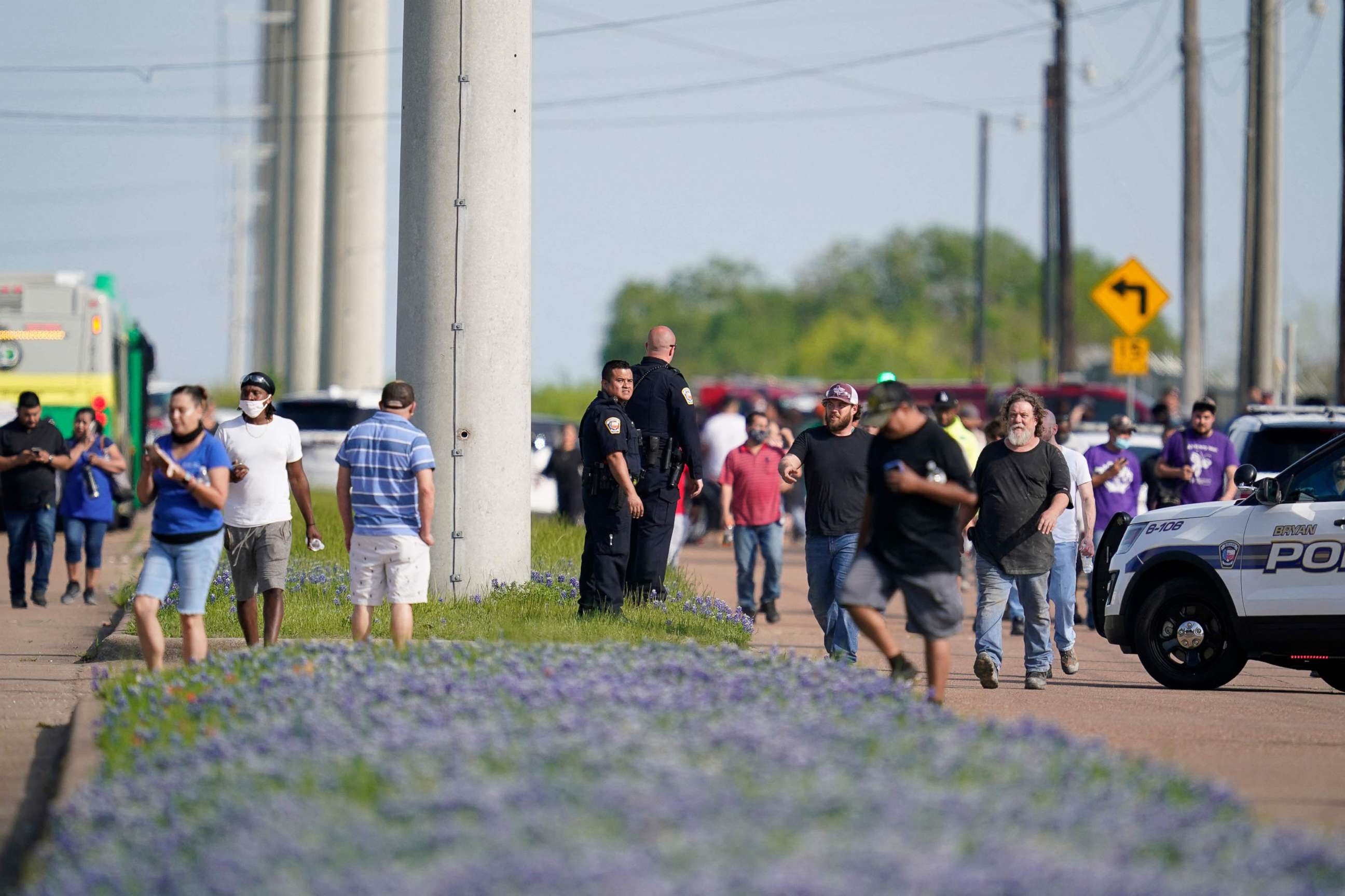 PHOTO: Bryan police officers direct workers away from the scene of a mass shooting at an industrial park in Bryan, Texas, April 8, 2021.