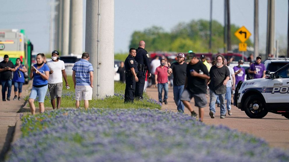 PHOTO: Bryan police officers direct workers away from the scene of a mass shooting at an industrial park in Bryan, Texas, April 8, 2021.