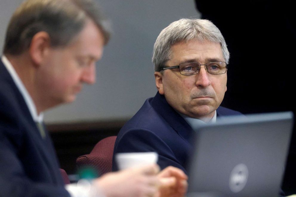 PHOTO: Travis McMichael, center left, speaks with his attorney during the sentencing of his and his father Greg McMichael, distant right, and neighbor, William "Roddie" Bryan, Jan. 7, 2022, in Brunswick, Ga.