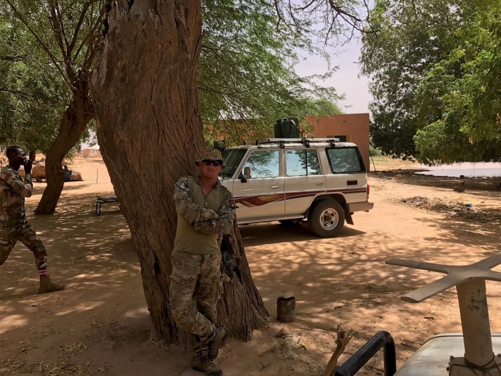 PHOTO: Army Staff Sgt. Bryan Black, who was killed in action by ISIS on Oct. 4, 2017, stands in foreground near a CIA surveillance team's truck.