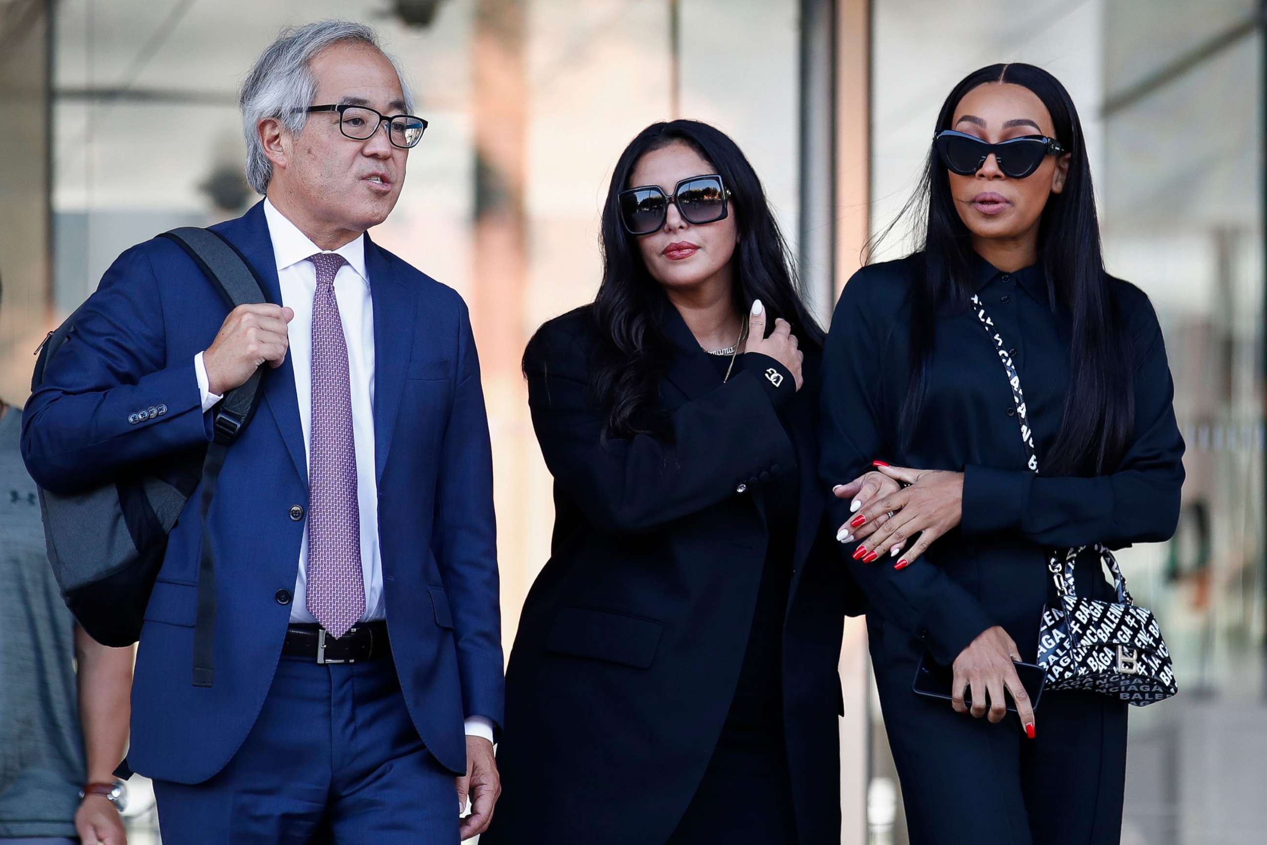 PHOTO: Vanessa Bryant (C), the widow of the late Kobe Bryant, flanked by her trial lawyer, Luis Li (L), and friend, Sydney Leroux (R), leaves a federal courthouse in Los Angeles, Aug. 23, 2022. 