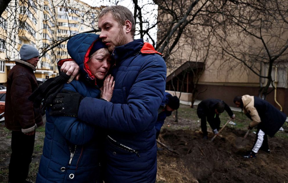 PHOTO: Serhii Lahovskyi, 26, hugs Ludmyla Verginska, 51, as they mourn their friend  Ihor Lytvynenko, who according to residents was killed by Russian Soldiers, after they found him beside a basement, following his burial in Bucha, Ukraine April 5, 2022.