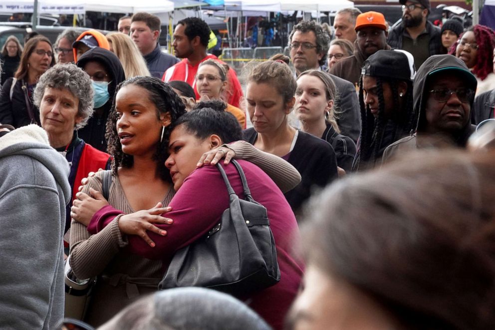 PHOTO: People participate in a vigil to honor the 10 people killed in Saturday's shooting at Tops market, May 17, 2022, in Buffalo, N.Y. 