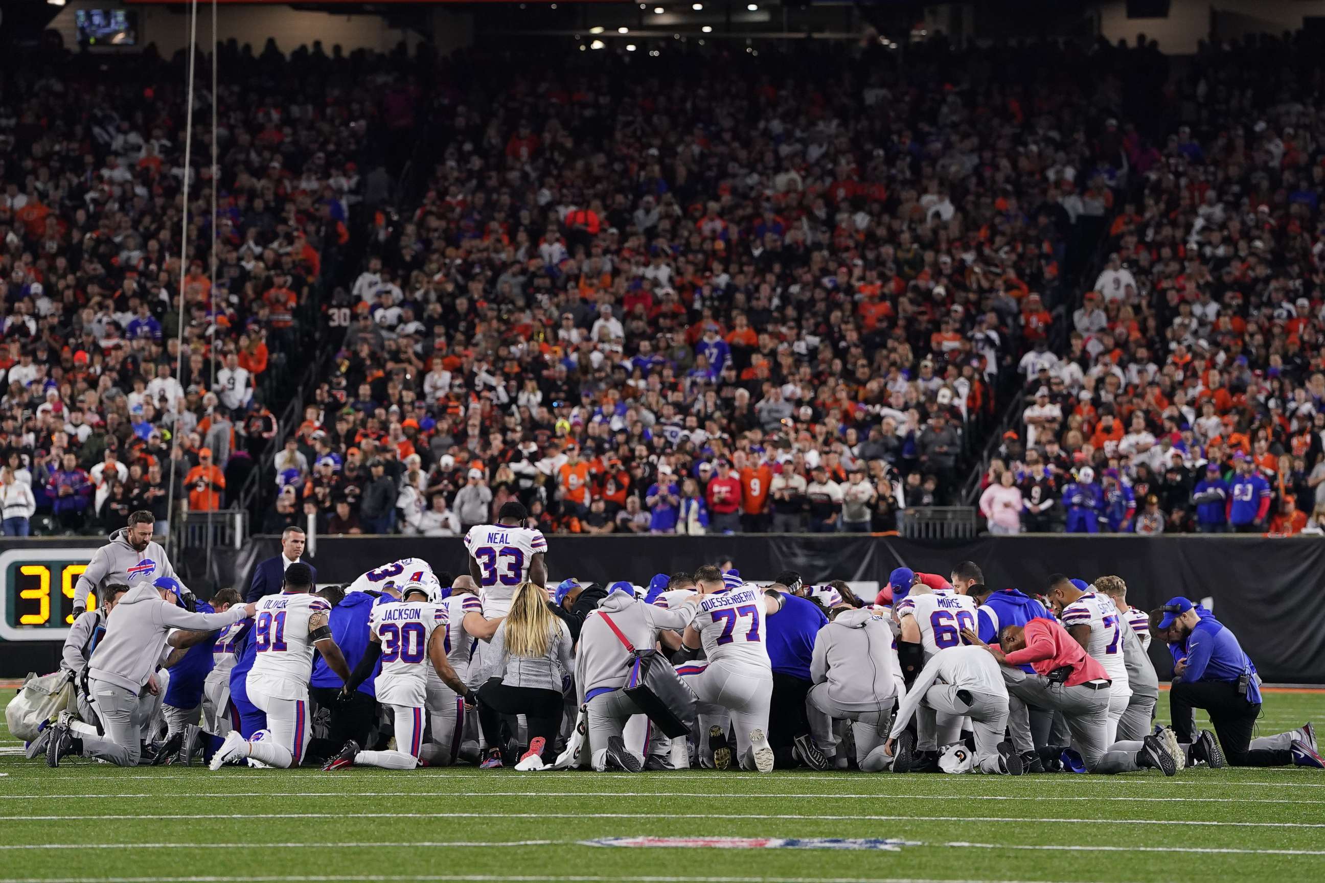 PHOTO: Buffalo Bills players huddle and pray after teammate Damar Hamlin collapsed on the field after making a tackle against the Cincinnati Bengals during the first quarter Jan. 2, 2023 in Cincinnati.