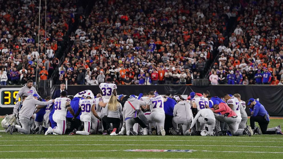 PHOTO: Buffalo Bills players huddle and pray after teammate Damar Hamlin collapsed on the field after making a tackle against the Cincinnati Bengals during the first quarter Jan. 2, 2023 in Cincinnati.