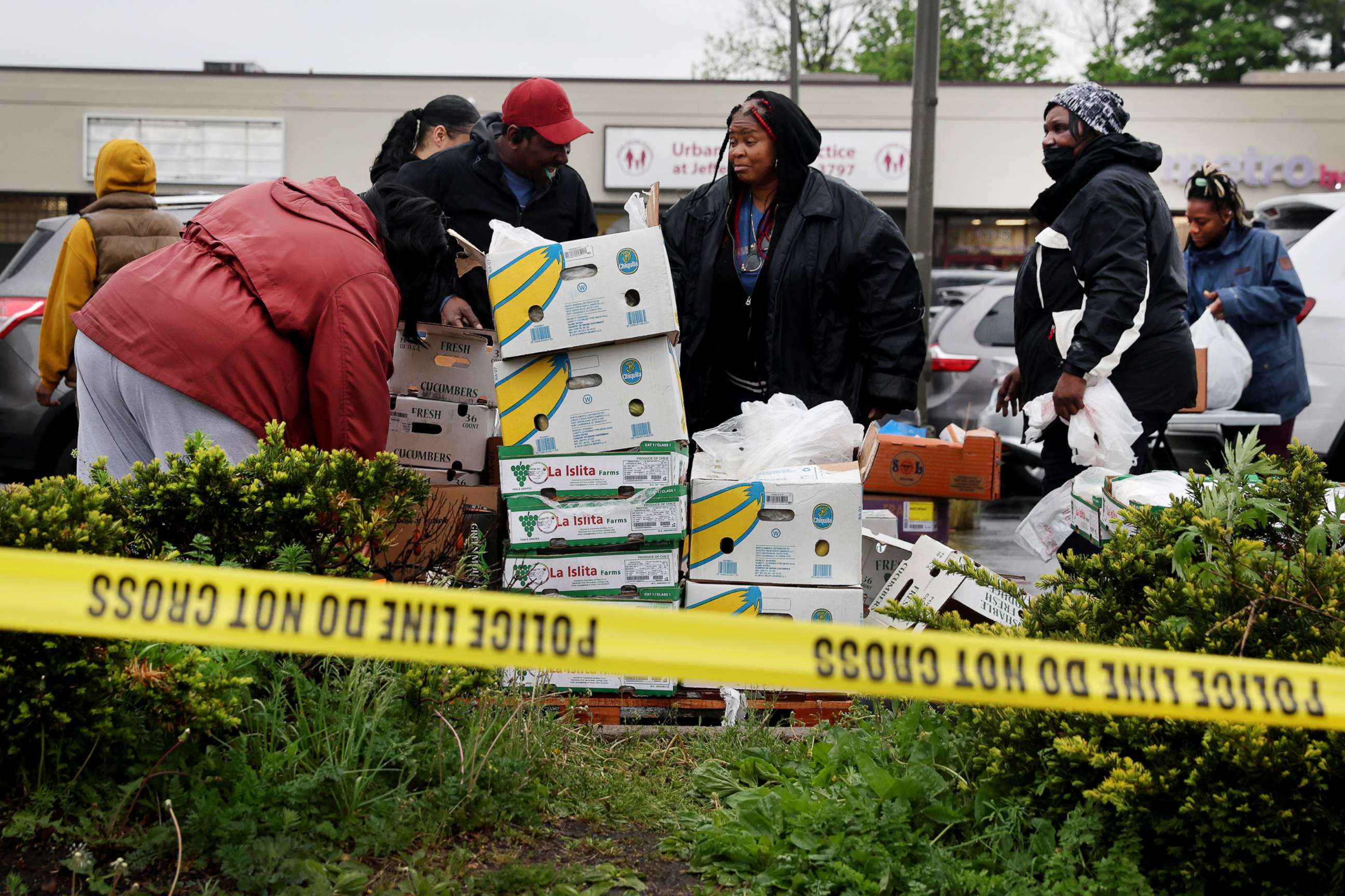 PHOTO: Workers with Rehoboth House of Prayer pass out donated groceries to residents living near the location of the Tops market shooting on May 16, 2022, in Buffalo, New York.
