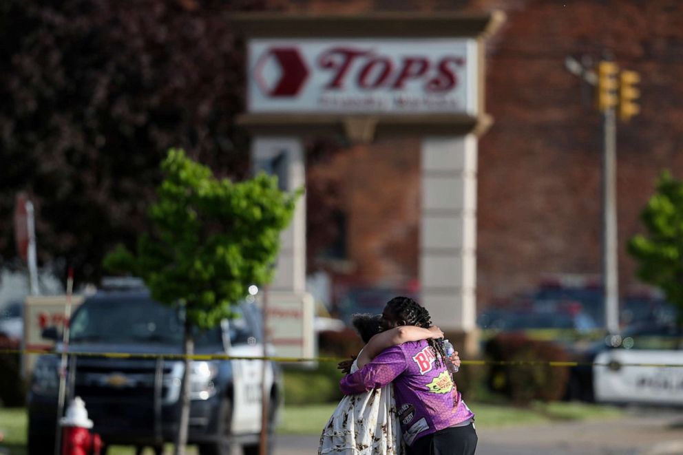 PHOTO: People hug outside the scene after a shooting at a supermarket, May 14, 2022, in Buffalo, N.Y.