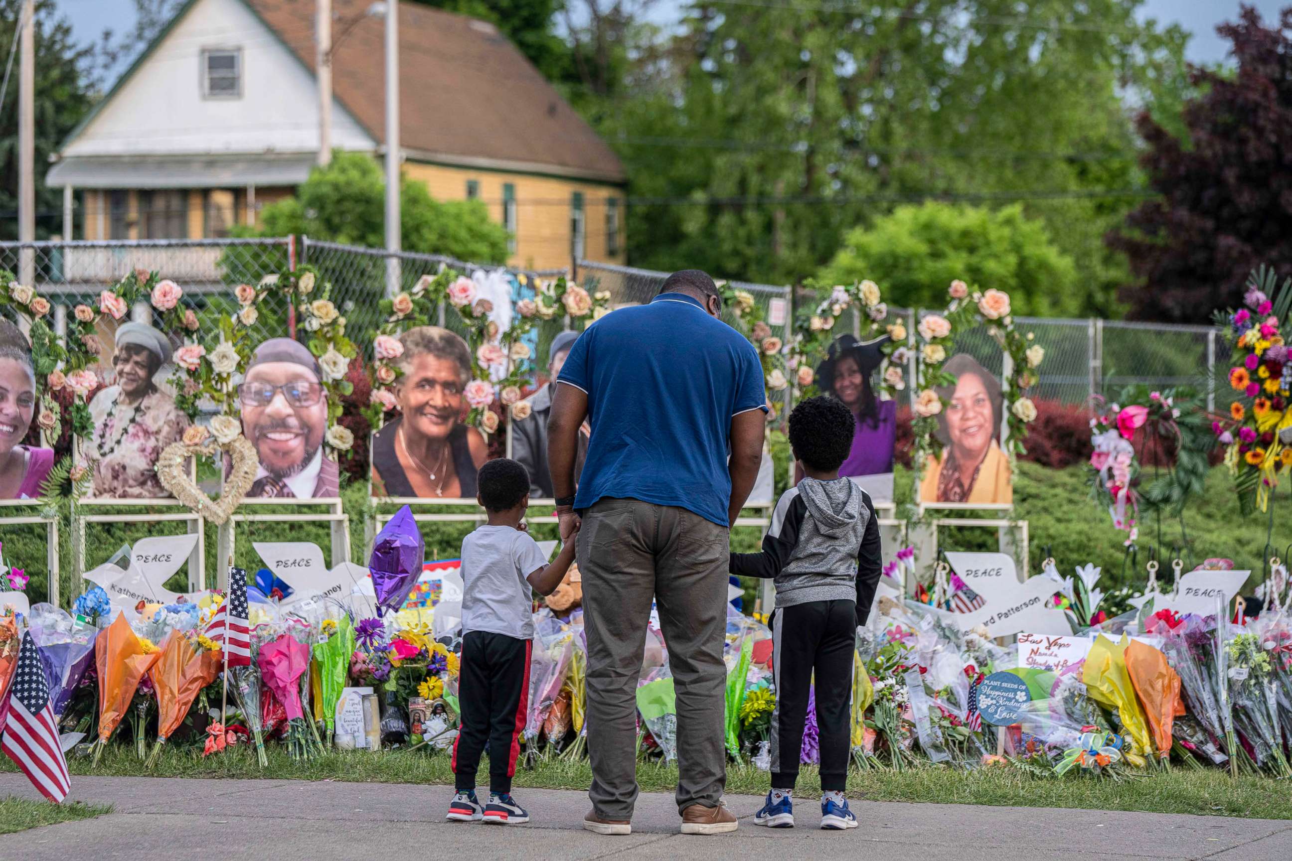 PHOTO: Mourners visit a memorial near the Tops Friendly Market where 10 people were killed in a shooting rampage in Buffalo, N.Y., May 24, 2022. 