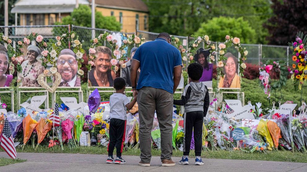 PHOTO: Mourners visit a memorial near the Tops Friendly Market where 10 people were killed in a shooting rampage in Buffalo, NY, May 24, 2022. 