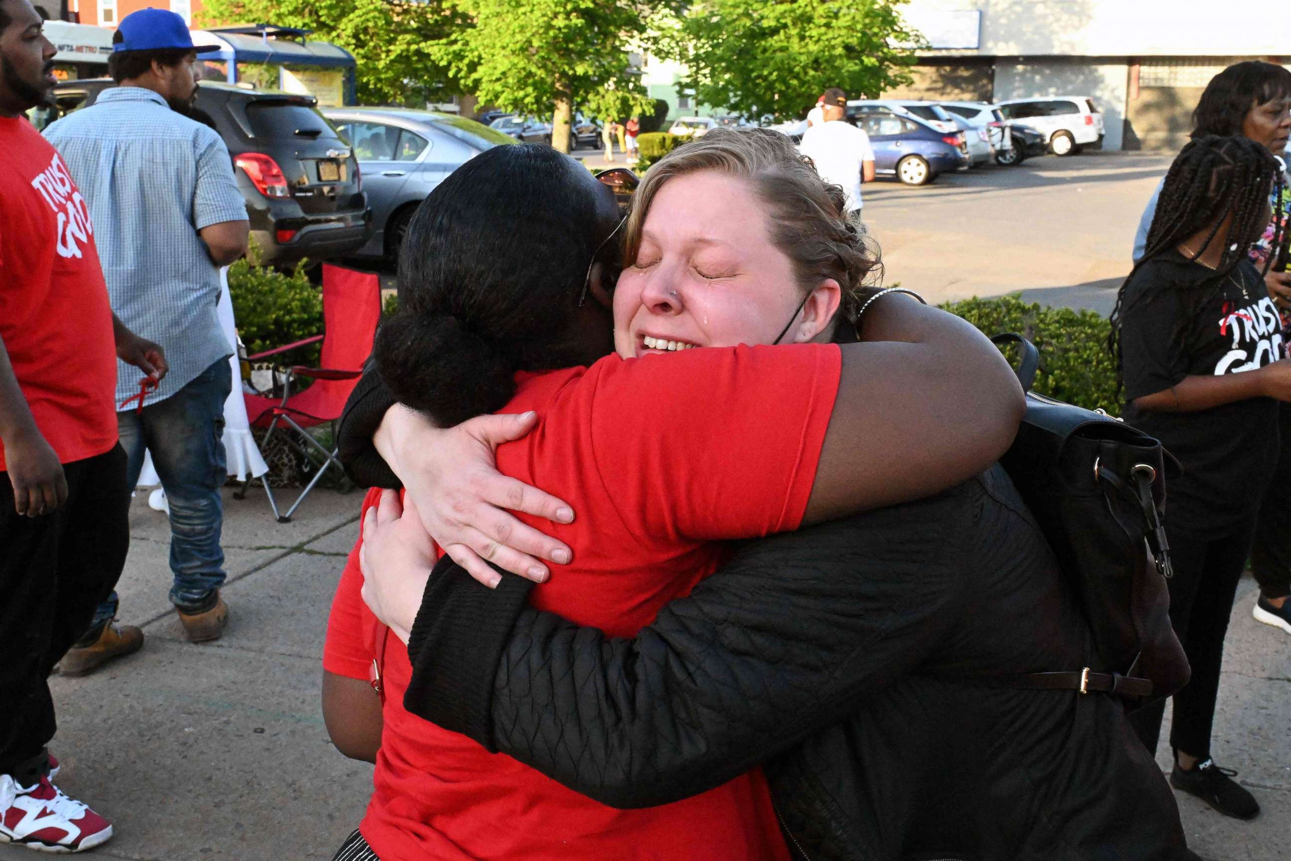 PHOTO: People mourn near a Tops supermarket in Buffalo, N.Y., on May 15, 2022, the day after a gunman shot dead 10 people.