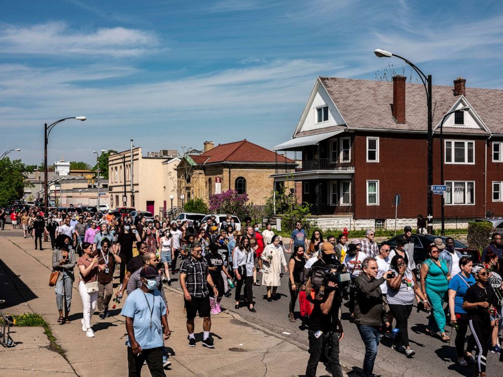 PHOTO: Community members, religious leaders and activists march through a neighborhood on Sunday near the Tops supermarket in Buffalo, N.Y., where 10 people were killed a day earlier, May 15, 2022.