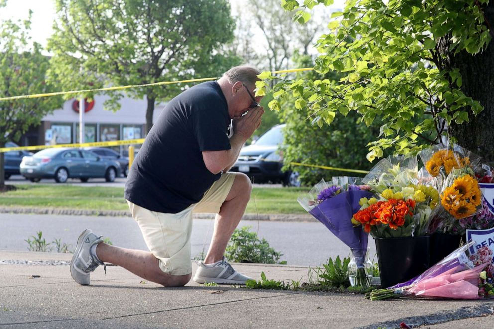 PHOTO: David Lang of Cheektowaga, a suburb of Buffalo, prays at a memorial across the street from the Tops supermarket where a gunman killed ten people in Buffalo, NY, May 15, 2022.