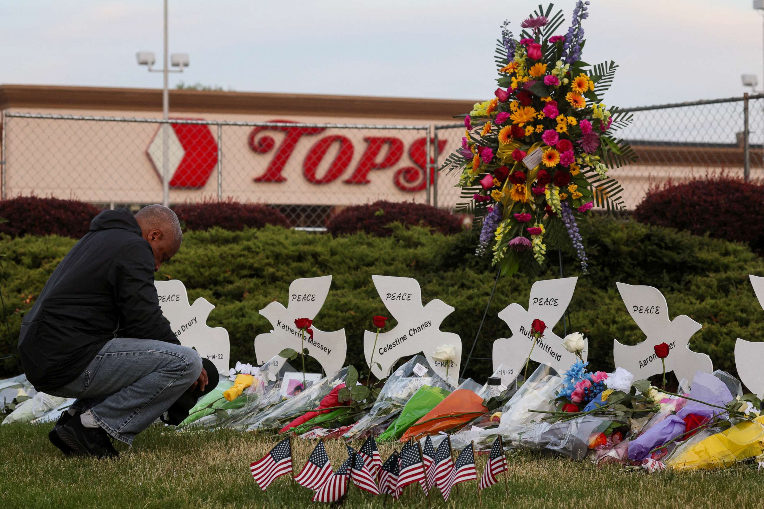 PHOTO: A man prays at a memorial at the scene of a weekend shooting at a Tops supermarket in Buffalo, N.Y., May 19, 2022.