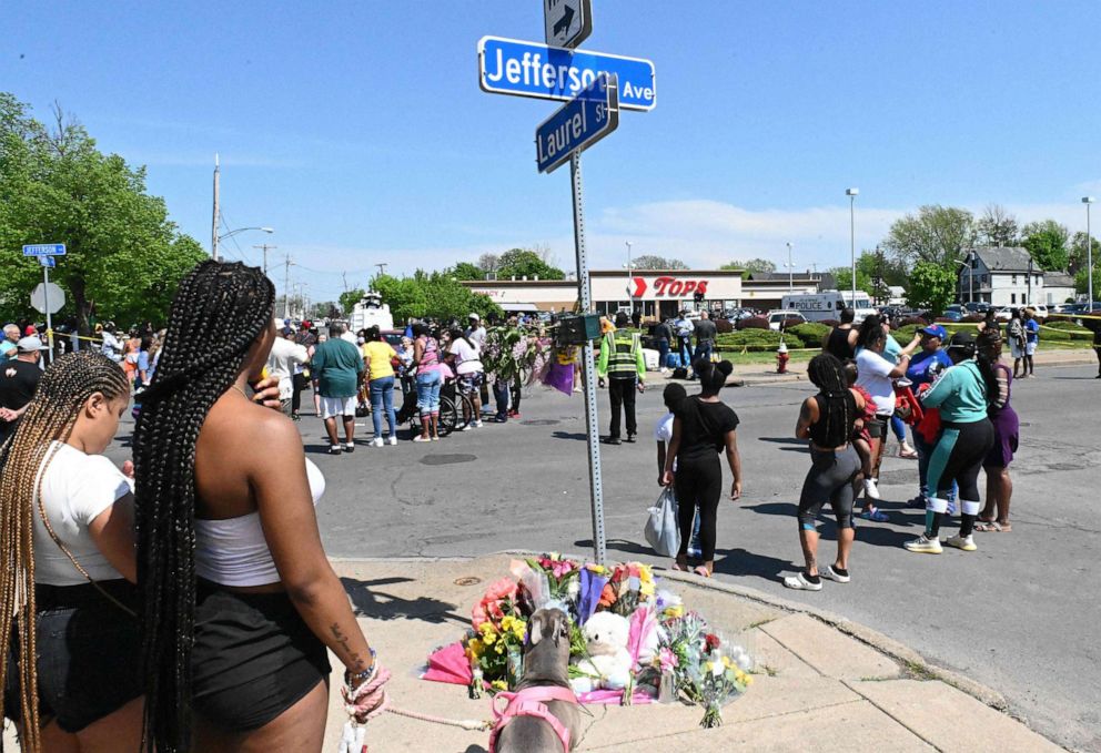 PHOTO: Mourners gather near a Tops supermarket in Buffalo, New York, May 15, 2022. Grieving residents held vigils Sunday after a white gunman shot dead 10 people at a grocery store in a racially-motivated rampage.