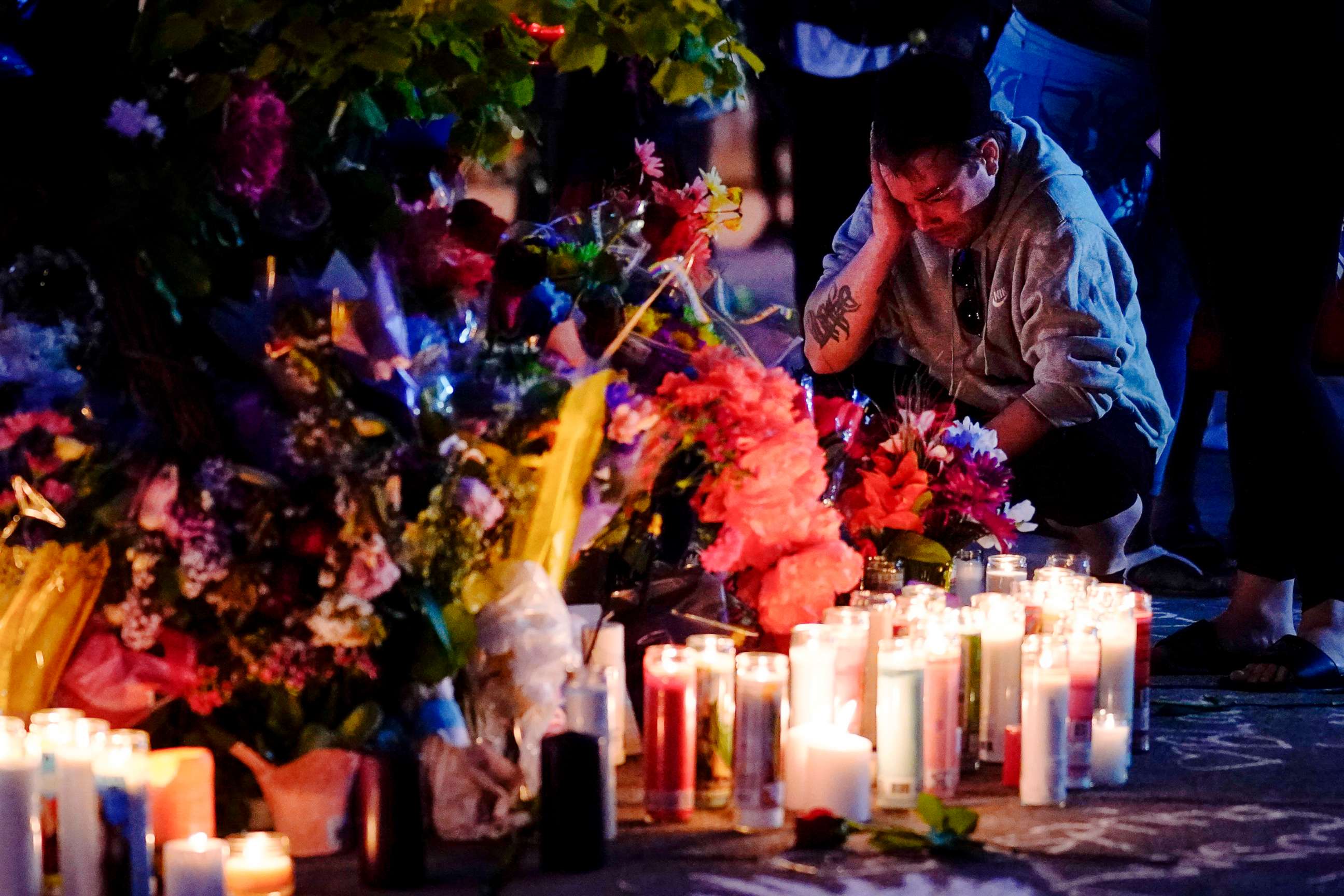 PHOTO: A person pays respects outside the scene of a May 14 mass shooting at a supermarket in Buffalo, N.Y., May 15, 2022.