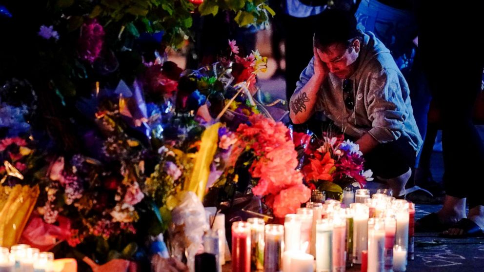 PHOTO: A person pays respects outside the scene of a May 14 mass shooting at a supermarket in Buffalo, N.Y., May 15, 2022.