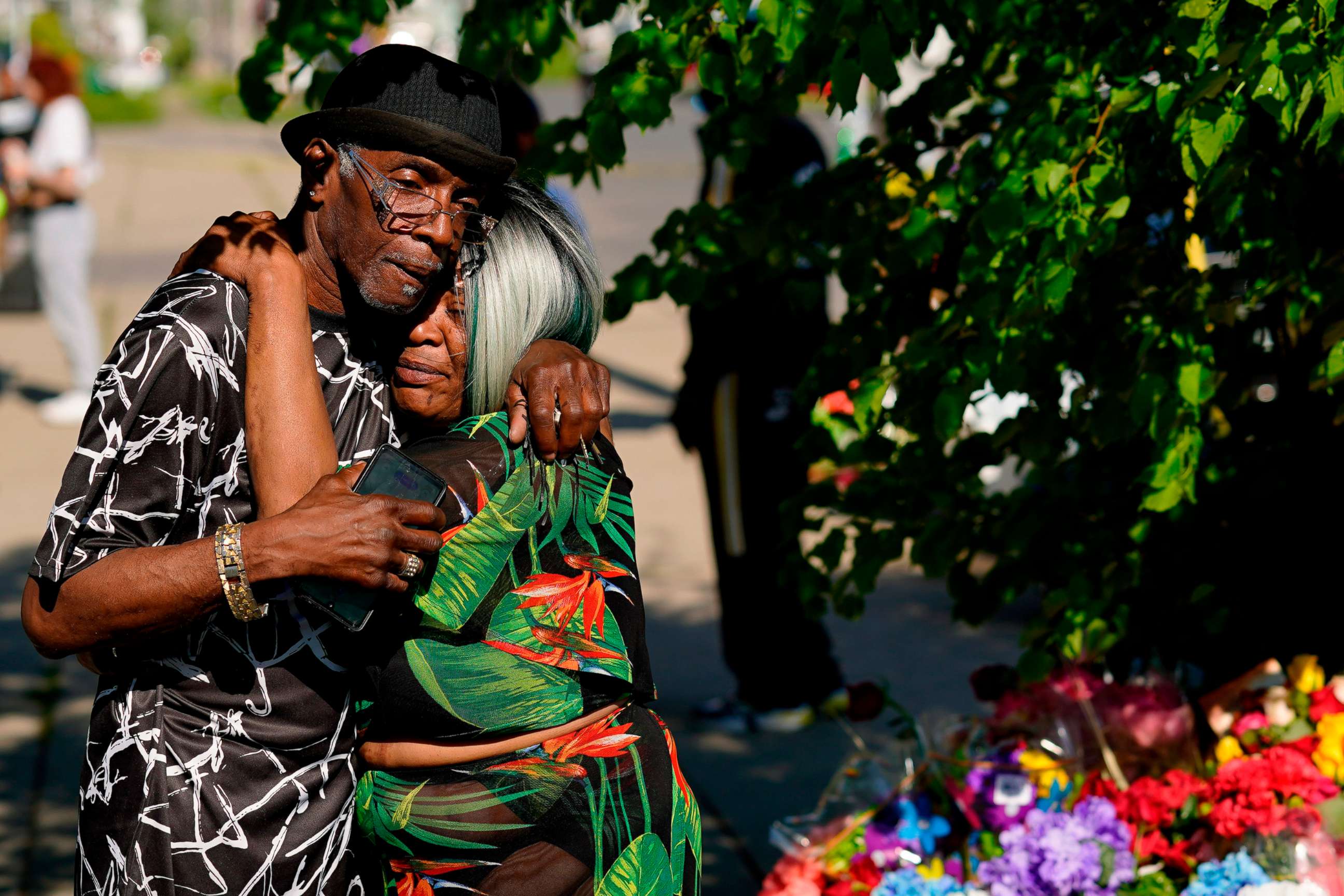 PHOTO: People embrace outside the scene of a mass shooting at a supermarket a day earlier, in Buffalo, N.Y., May 15, 2022.