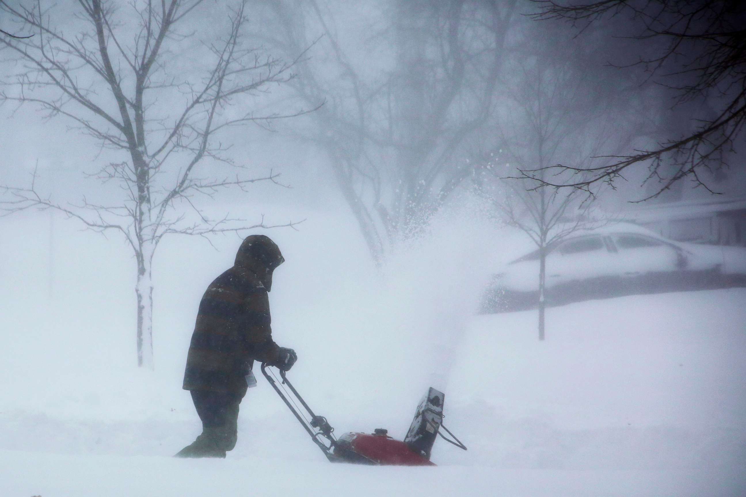 PHOTO: A person clears snow as a winter storm rolls through Western New York, Dec. 24, 2022, in Amherst N.Y.